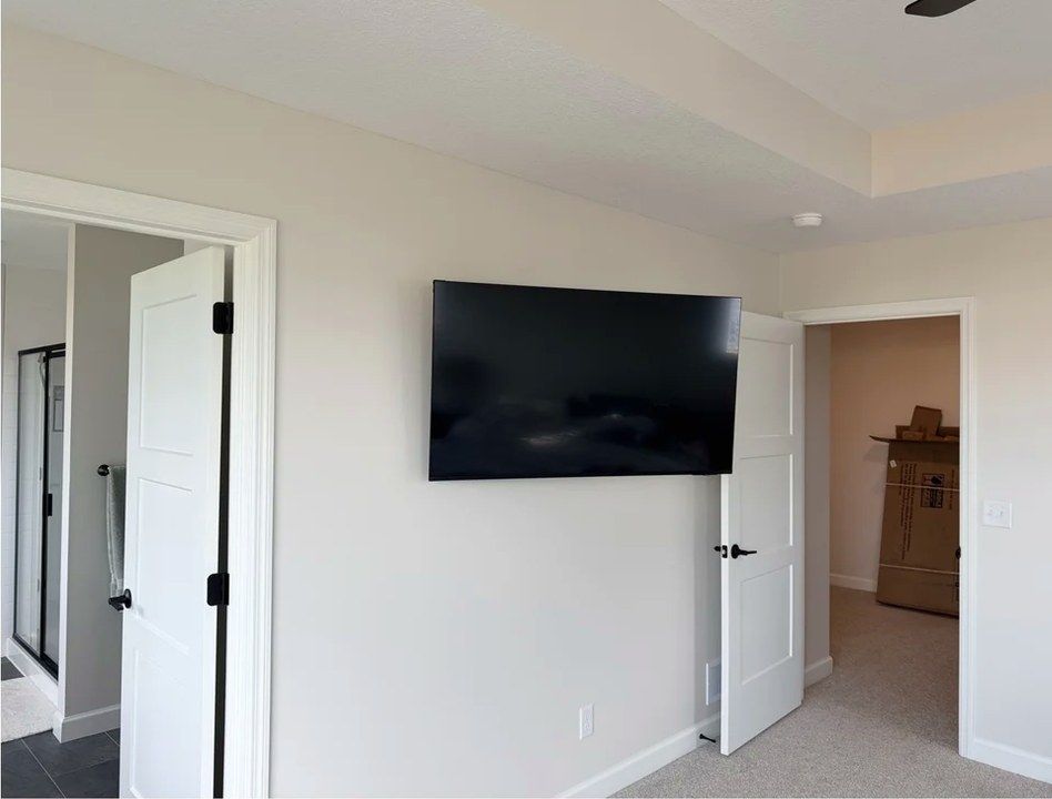 Bedroom TV mounted on drywall