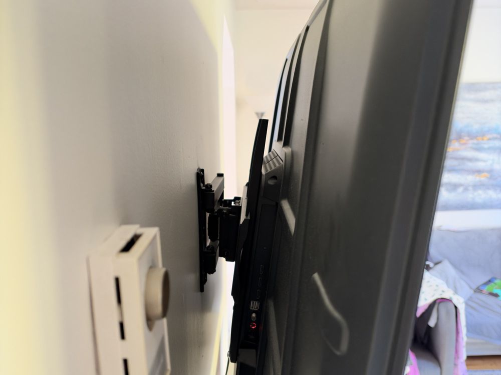 Recessed power kit and in-wall cable plate behind a wall-mounted TV in Halifax