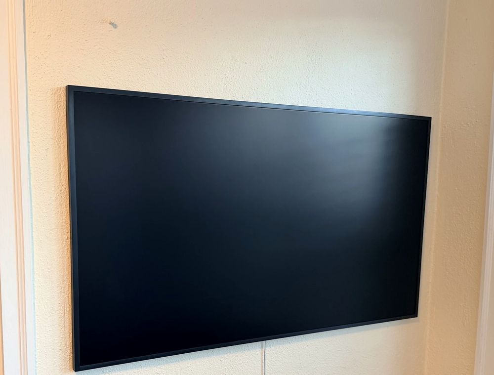Samsung Frame TV mounted flush on a textured wall in Halifax