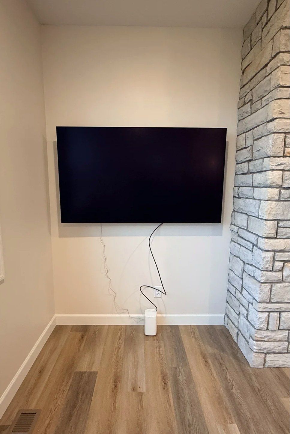 TV mounted beside a stone column