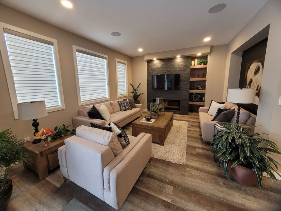 TV mounted on a stone feature wall above a linear fireplace in a living room